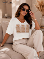 Weiße Damen Bluse mit V-Ausschnitt und goldener Strass Verzierung